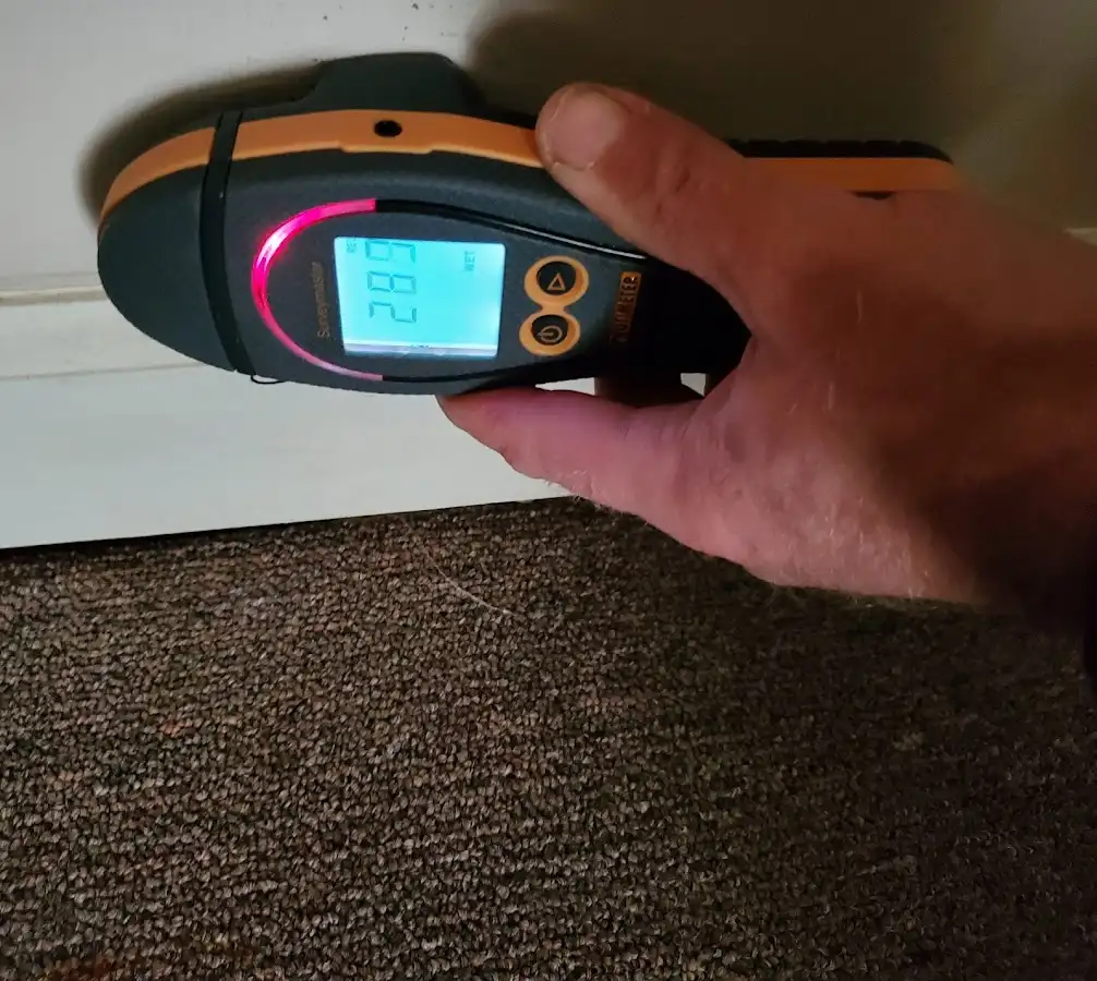 Moisture detection at baseboard during Storm Damage Restoration in Tewksbury